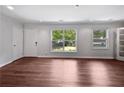Bright living room with hardwood floors and large windows providing natural light and pleasant outdoor views at 2122 Belhaven Se Ln, Atlanta, GA 30315