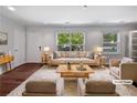 Cozy living room featuring neutral furniture, a plush rug, and sunlit windows offering lovely views at 2122 Belhaven Se Ln, Atlanta, GA 30315