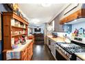 Traditional kitchen featuring stainless steel appliances, custom cabinets, and hardwood floors at 5795 Stewart Mill Rd, Douglasville, GA 30135