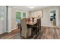 Cozy dining room with wood floors, panelled walls, and an ornate wood table at 5365 Crow Rd, Cumming, GA 30041