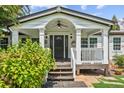 Charming home exterior with inviting front porch, trimmed with classic white columns at 5365 Crow Rd, Cumming, GA 30041