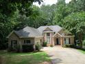 Two-story brick home with attached garage and lush landscaping at 1269 Heritage Dr, Villa Rica, GA 30180