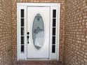 Elegant front door with decorative glass insert and sidelights, set in a brick surround at 1269 Heritage Dr, Villa Rica, GA 30180