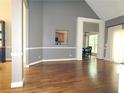 Spacious living room with hardwood floors, neutral paint, and arched doorways at 1269 Heritage Dr, Villa Rica, GA 30180