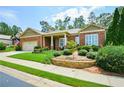 Well-maintained brick home with a manicured lawn and stone accents at 705 Springer Mountain Dr, Canton, GA 30114