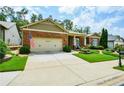 Beautiful brick home with a two-car garage, lush lawn, and manicured landscaping at 705 Springer Mountain Dr, Canton, GA 30114