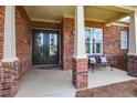 Inviting front porch with decorative brick columns and a charming bench at 705 Springer Mountain Dr, Canton, GA 30114