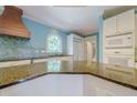 Kitchen featuring granite counters, blue walls, and a tile backsplash at 1357 Baniff Ct, Snellville, GA 30078
