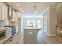 Spacious open-concept kitchen boasts a center island with a sink and stainless appliances at 1956 Deco Dr, Kennesaw, GA 30144