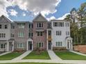 Three story townhome community with inviting front yards at 1996 Deco Dr, Kennesaw, GA 30144