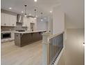 Kitchen featuring a large center island, pendant lights, stainless steel appliances and neutral colored cabinets at 1980 Deco Dr, Kennesaw, GA 30144