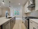 Bright kitchen featuring a stainless steel stove, herringbone backsplash, and an island with a sink at 1980 Deco Dr, Kennesaw, GA 30144