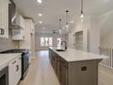 Modern kitchen with a large center island, stainless steel appliances, and stylish pendant lighting at 1980 Deco Dr, Kennesaw, GA 30144