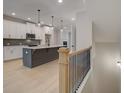 Bright kitchen features white cabinetry, gray backsplash and a large center island with pendant lighting above at 1988 Deco Dr, Kennesaw, GA 30144