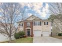 Charming two-story home featuring a brick facade, two-car garage, and well-maintained landscaping at 1623 Bradmere Ln, Lithia Springs, GA 30122