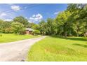 Exterior shot of a home showcasing a well-manicured lawn and a winding driveway at 1417 Iris Lake Rd, Mcdonough, GA 30252