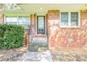 Inviting front entrance showcasing a brick facade, stairs, and a door with glass at 1417 Iris Lake Rd, Mcdonough, GA 30252