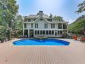 Inviting swimming pool with a large deck and lush landscaping at 1012 Jubilee Way, Powder Springs, GA 30127