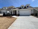 Charming home with a two-car garage and inviting curb appeal with a pristine driveway and manicured lawn at 3577 Fishpond Cir, Dacula, GA 30019