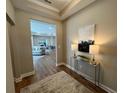 Foyer featuring a stylish console table, lamps, artwork, and beautiful hardwood floors at 3577 Fishpond Cir, Dacula, GA 30019