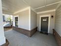 Covered front porch with a stylish entry door and attractive brick accents at 3577 Fishpond Cir, Dacula, GA 30019
