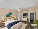 Cozy bedroom featuring a ceiling fan, hardwood floors, and neutral walls at 424 Eglington Trl, Locust Grove, GA 30248