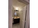 Bathroom showcasing vanity with sink and mirror, tile flooring, and a separate door at 1090 Brittwood Pl, Norcross, GA 30093