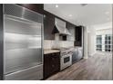 Modern kitchen featuring stainless steel appliances, granite countertops, and dark wood cabinetry at 3325 Piedmont Ne Rd # 1801, Atlanta, GA 30305