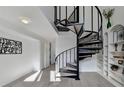 Bright foyer featuring a modern spiral staircase and white built-in shelves at 882 Cedar Canyon Se Sq, Marietta, GA 30067