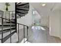 Living room with a unique spiral staircase, large windows, and modern gray flooring at 882 Cedar Canyon Se Sq, Marietta, GA 30067