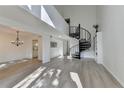 Spacious living room with a modern chandelier, hardwood floors, and a spiral staircase at 882 Cedar Canyon Se Sq, Marietta, GA 30067