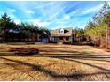 House exterior showcasing a large yard and attached garage at 136 Rainey Rd, Temple, GA 30179