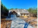 White farmhouse exterior with a welcoming front porch at 136 Rainey Rd, Temple, GA 30179