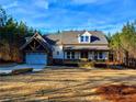 Charming farmhouse exterior, featuring a spacious yard and attached garage at 136 Rainey Rd, Temple, GA 30179