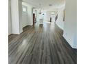 Spacious living room with hardwood floors, white walls, and an open floor plan to the kitchen at 4440 Sims Park Overlook, Suwanee, GA 30024