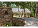 Charming home with stone accents and a beautifully landscaped yard, offering curb appeal and privacy at 2010 Stonehedge Rd, Roswell, GA 30075
