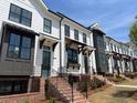 A modern townhouse complex boasting white facades, black-framed windows, and landscaped grounds at 630 Skytop Dr # 157, Cumming, GA 30040