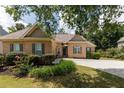 Two-story brick home exterior, lush landscaping, and a large driveway at 186 Thorn Creek Way, Dallas, GA 30157