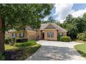 Beautiful brick home showcasing manicured lawns, a long driveway, and mature trees at 186 Thorn Creek Way, Dallas, GA 30157