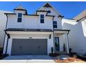 Charming two-story home featuring a two-car garage, a covered entryway and a light-colored facade at 635 Skytop Dr, Cumming, GA 30040