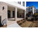 Charming brick home with a covered front porch, black-framed windows and manicured landscaping at 362 Olmstead Way # 23, Alpharetta, GA 30002