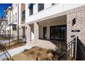 Inviting brick front porch with decorative columns, featuring modern exterior lighting and manicured landscaping at 362 Olmstead Way # 23, Alpharetta, GA 30002