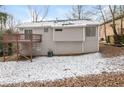 View of the back of the house with a wooden deck and a snowy yard at 2920 Cushing Ct, Jonesboro, GA 30236