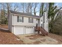 Two-story house with a two-car garage and a wooden deck, set on a sloping lot at 2920 Cushing Ct, Jonesboro, GA 30236