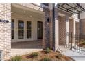 Close-up of front porch showcasing brickwork and elegant architectural details at 352 Olmstead Way # 28, Alpharetta, GA 30022
