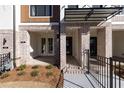 Inviting brick front porch with decorative columns and wrought iron fencing at 352 Olmstead Way # 28, Alpharetta, GA 30022