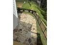 Outdoor stone patio with built-in fire pit and a wrought-iron fence along the perimeter, ideal for entertaining at 1065 Low Water Nw Xing, Acworth, GA 30101