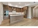 Bright kitchen with stainless steel appliances, island, and custom cabinetry at 5365 Maggie Mae Ln, Cumming, GA 30028