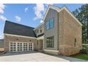 Charming brick house with large windows and a spacious driveway at 104 Cottage Gate Ln, Roswell, GA 30076