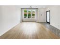 Bright living room with hardwood floors, modern lighting, and large windows for natural light at 371 Pratt Se Dr # 203, Atlanta, GA 30315